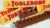 TOBLERONE Chocolate Ao Leite Nougat De Mel E Amêndoas Toblerone Caixa 100G – Importado